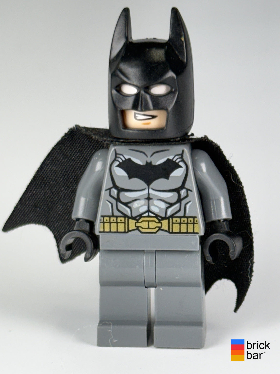 Batman dim002 LEGO Dimensions minifigure front, gray suit, black cowl and visibly worn black cape