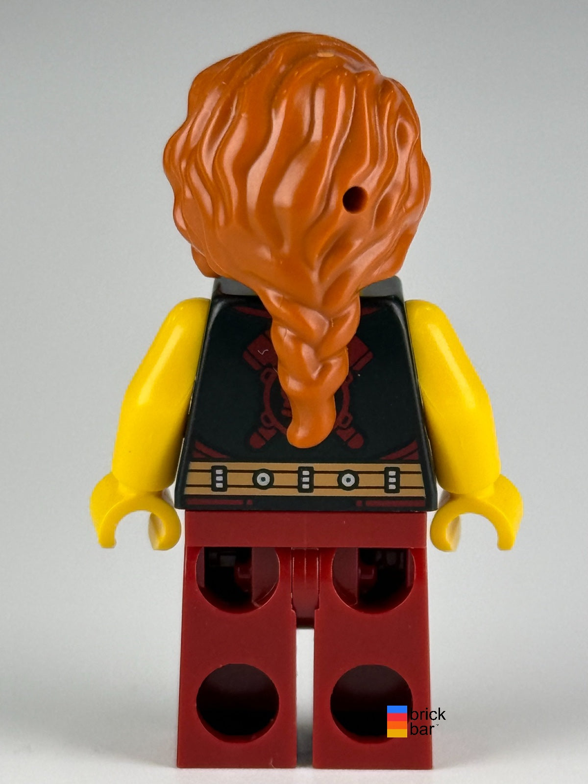 LEGO Viking Blacksmith idea167 with dark orange braided hair and dark red overalls — back view