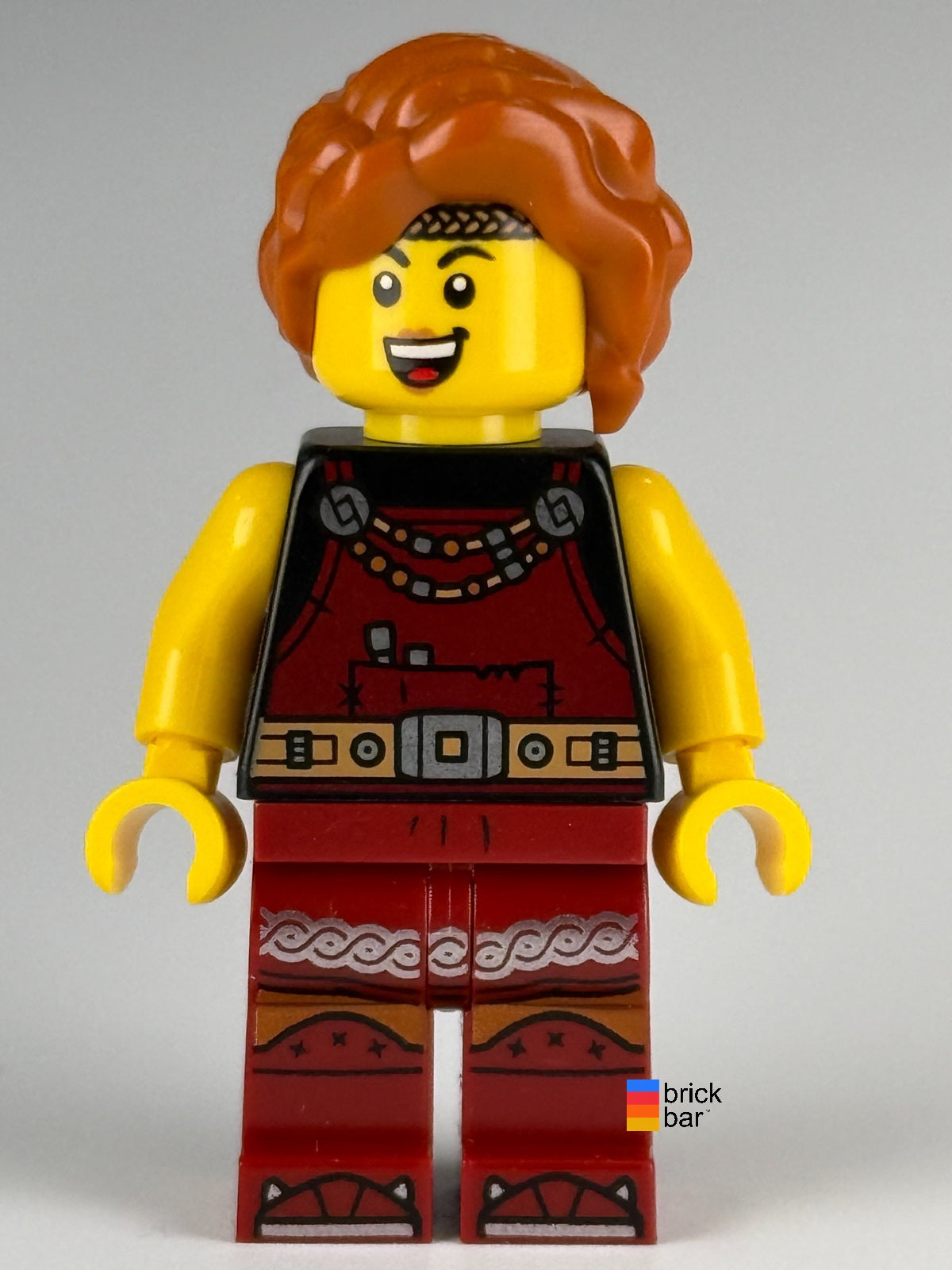 LEGO Viking Blacksmith idea167 with dark orange braided hair and dark red overalls — front view