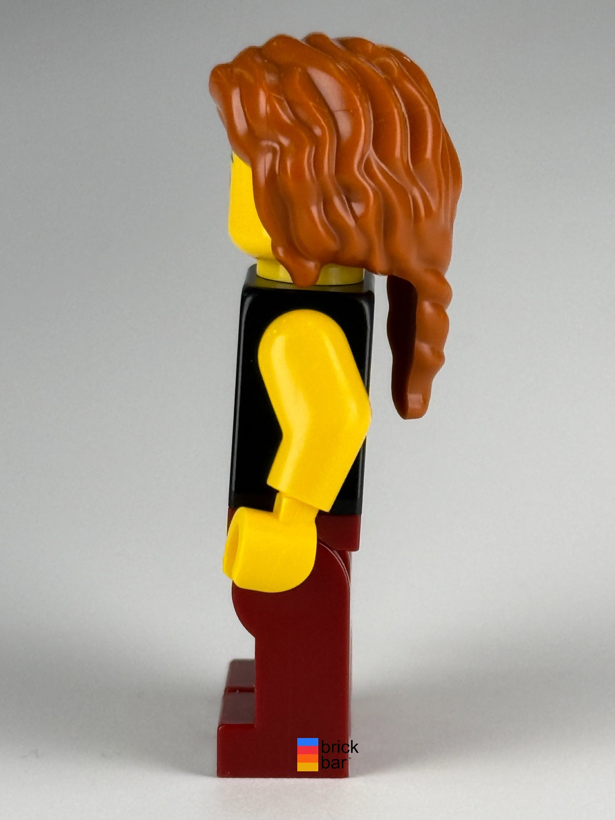 LEGO Viking Blacksmith idea167 with dark orange braided hair and dark red overalls — side view
