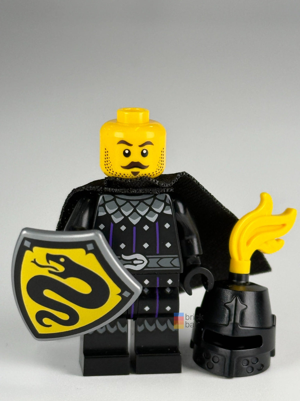 Serpent Knight cas593 front without helmet, moustached neutral expression, black cape and serpent shield