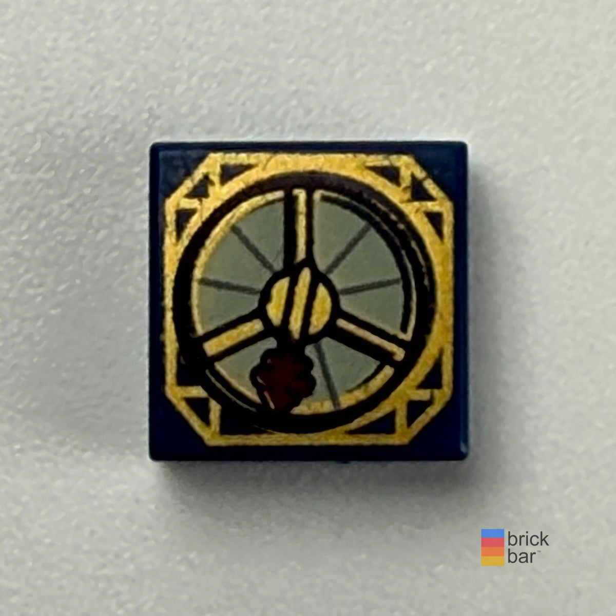 Dark blue LEGO Jack Sparrow compass tile 3070pb052 with gold details and thick dark red needle