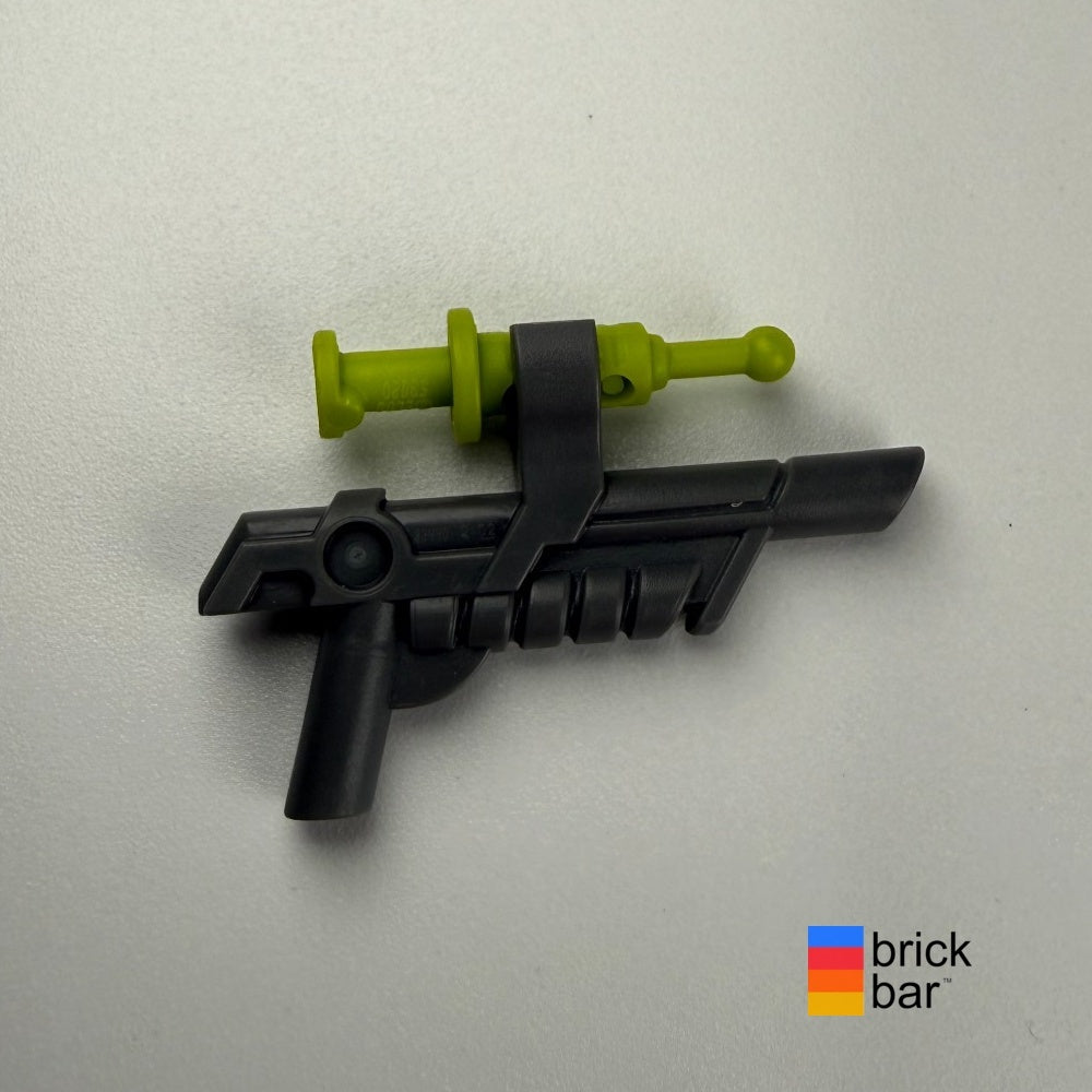 Dark bluish gray Jurassic World tranquilizer gun 15445 with lime dart, photographed by Brick Bar.