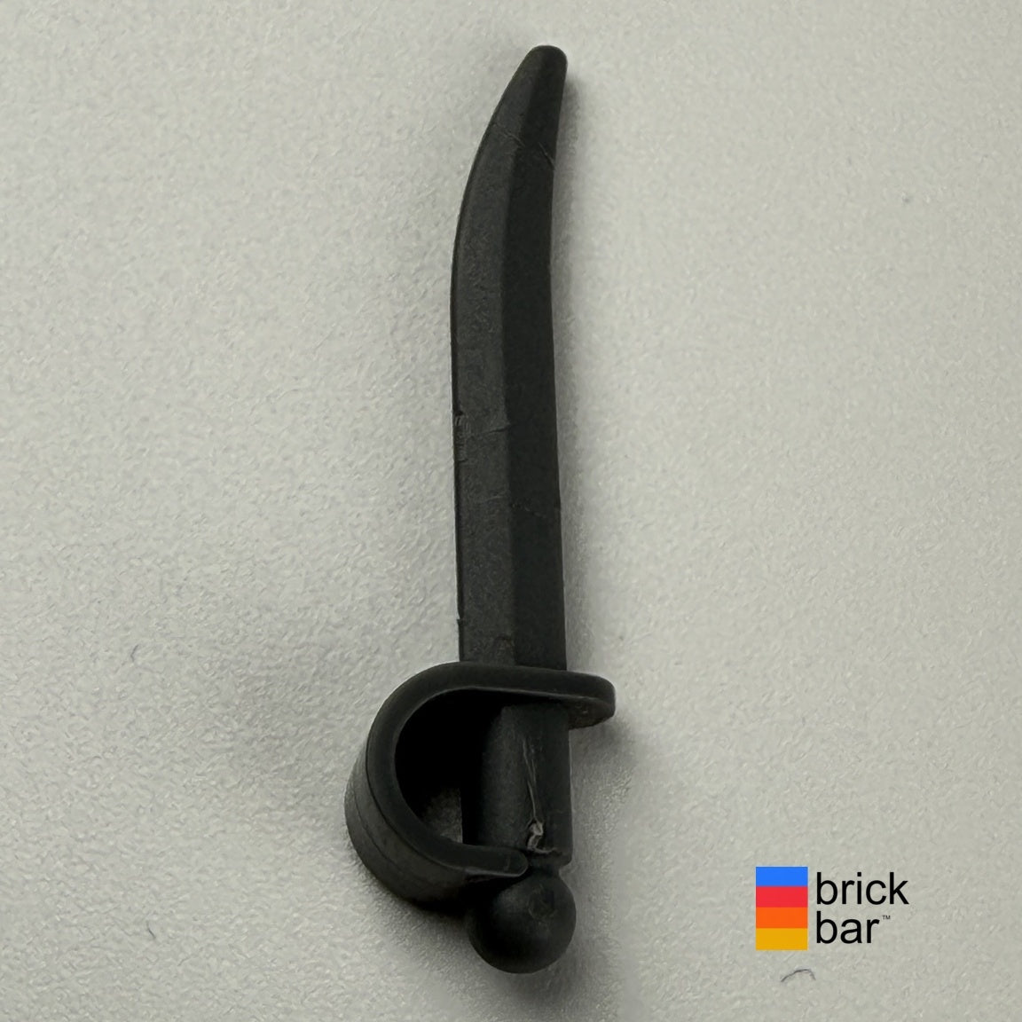 Pirates cutlass 1624, curved blade and enclosed hand guard, side view photographed by Brick Bar.