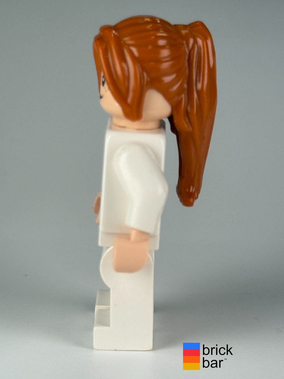 Back view of LEGO Marvel Super Heroes Pepper Potts in white suit, minifigure sh0068.