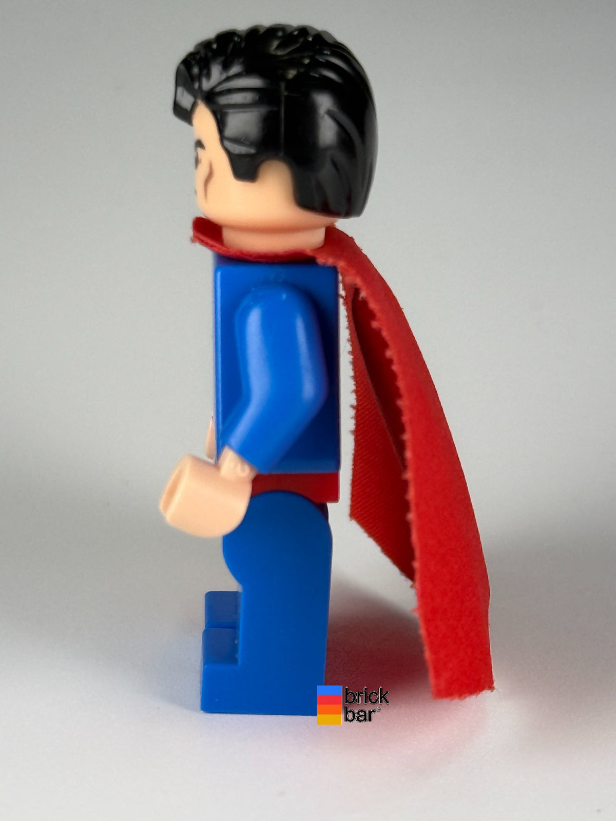 Superman - Blue Suit, Spongy Cape, Frown / Red Eyes sh0156 LEGO minifigure, side view